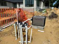 Outdoor pool heater beside connected plumbing