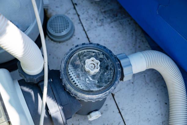 Pool pump strainer and circulation equipment beside an above-ground pool